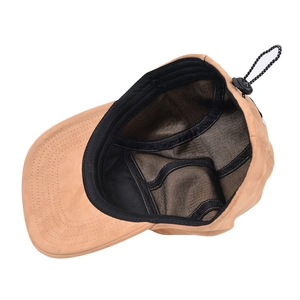 Detailed interior view of tan suede baseball cap with breathable mesh and cord adjuster