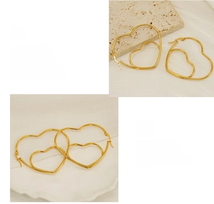 Close-up of golden double-heart dangle earrings with polished metallic finish