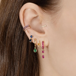 Golden earrings set with colorful multi-shape gemstones and rhinestones on ear model