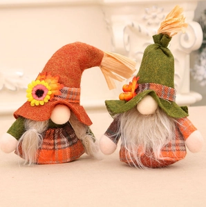 Detailed view of fall-themed plush gnomes with sunflowers, berries, and plaid fabric textures