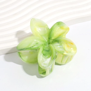 Macro shot of green and white marble floral hair claw clip in acetate material