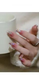 Macro shot of mixed shaped aurora flatback glass nail rhinestones on long acrylic nails