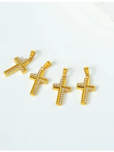 Detail of four golden cross pendants with micro-pave white cubic zirconia in a set