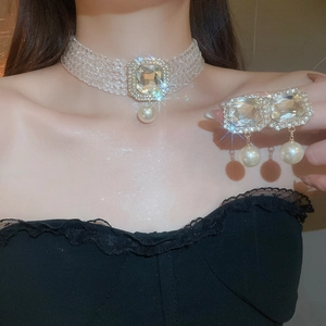 Detailed view of luxury multi-layer pearl choker with square crystal and gold drop earrings