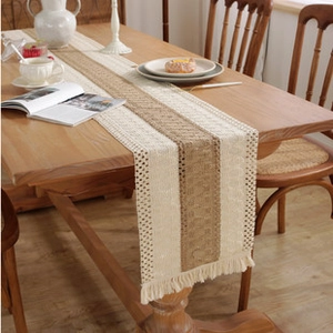 Close-up of beige and brown striped cotton linen table runner with woven tassels