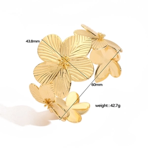 Detailed view of golden flower open bracelet with dimensions and brushed texture metal