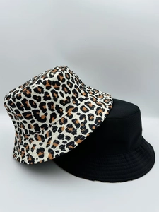 Detail view of double-sided leopard print and solid black reversible cotton bucket hats