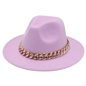 Pink felt fedora hat with a chunky gold acrylic chain band decoration on a white background