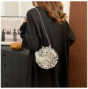 Silver rose-shaped clutch bag with 3D petal design and chain strap shown on model