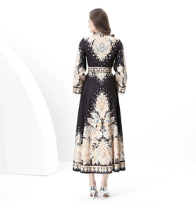 Detail of vintage palace style dress showing wide hem drape and paisley print patterns