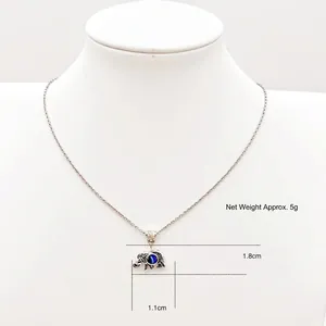 Detailed close-up of elephant pendant with evil eye stone and 1.8cm x 1.1cm dimensions