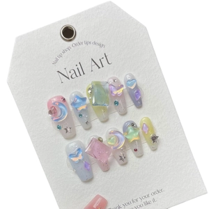 Colorful aurora press-on nails featuring 3D macaron moon and star charms with glitter