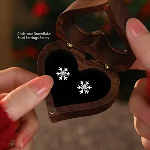 Elegant S925 sterling silver snowflake earrings in a heart-shaped wooden gift box