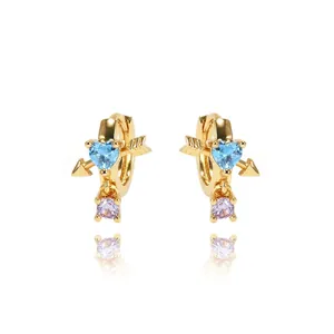 Gold heart earrings with blue gemstone and purple zircon featuring cupid arrow design