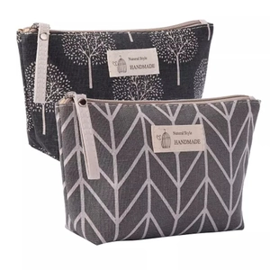 Canvas makeup bags with nature patterns and side handles shown on a white background