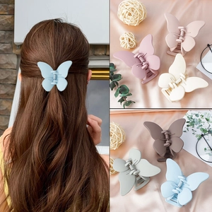 Matte butterfly hair claw clips in various colors shown on model and still life view