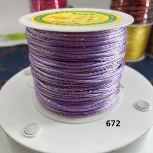 Macro shot of purple and gold metallic braided thread for handmade DIY jewelry crafting