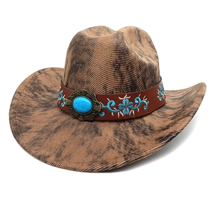 Detail of western cowboy hat with brown marble pattern and turquoise buckle band