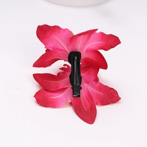 Detail view of pink cymbidium orchid hair clip with secure black metal alligator grip