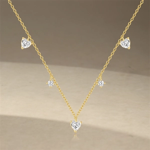 Close-up of S925 sterling silver gold necklace with heart and round zircon stones