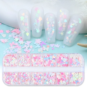 Close-up of 12-grid nail art sequins with iridescent hearts, stars and butterfly shapes