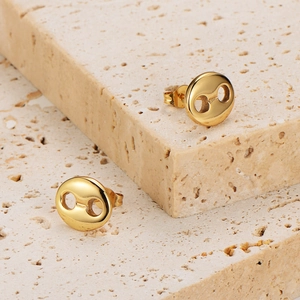 French vintage style gold plated coffee bean stud earrings on a natural stone background