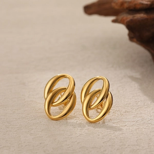 Polished 18K gold double oval hoop earrings featuring an elegant twisted minimalist design