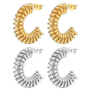 Twisted spring hoop earrings in gold and silver stainless steel finish on white background
