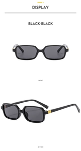 Detail of vintage square black sunglasses featuring iconic gold vertical ribbed metal hinges