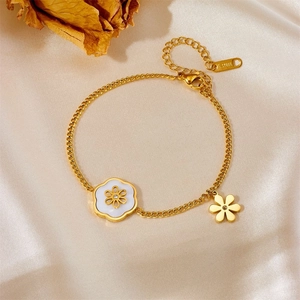 Golden flower bracelet in stainless steel with white shell petals on champagne silk cloth