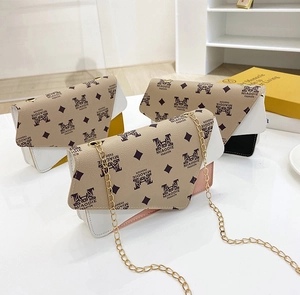 Detailed view of fashionable mini square bags with chain straps and monogram print