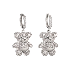 Close-up of silver bear earrings with white cubic zirconia pavé on a white background