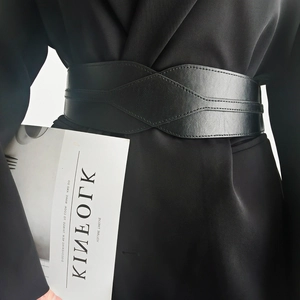 Detail of wide black leather corset belt with diamond stitching on a blazer coat
