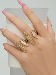 Detail of three-piece butterfly wing rings set in gold with pave zircon inlay