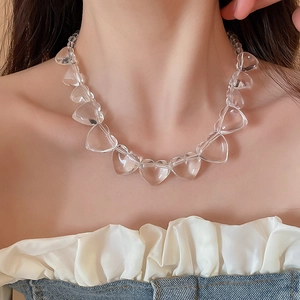 Close-up of clear acrylic heart-shaped beads on a stylish choker necklace for women