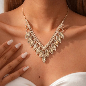 Detail of V-shaped fringe necklace with champagne crystals on a female model