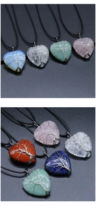 Detailed view of assorted natural stone heart pendants with wire-wrapped tree of life