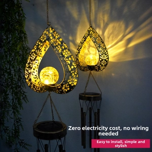 Solar powered heart hollow metal wind chime with warm yellow cracked glass ball light