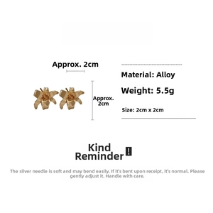 Detailed macro view of golden lily flower stud earrings with dimensions and material specs