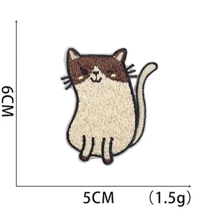 Macro shot of a cartoon cat embroidery patch with 6cm and 5cm size dimensions shown