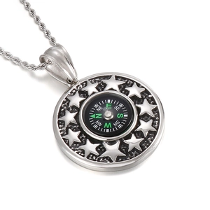 Stainless steel compass necklace with star relief and luminous green pointer details