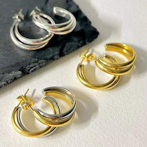 Three-ring intertwined C-shaped hoop earrings in gold, silver, and two-tone finishes