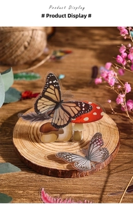 Detail shot of butterfly and mushroom stickers on a natural wooden display for journaling