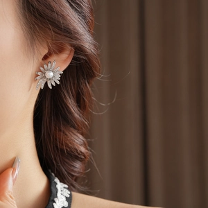 Close-up of zircon sunflower pearl earring on model showcasing vintage French style