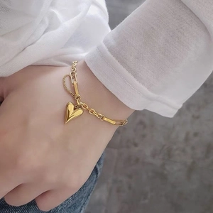Vintage hip-hop heart pendant gold necklace on model with stylish chain detail
