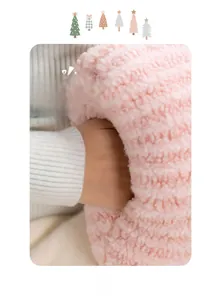 Detail of pink plush hand warmer pillow showing soft lamb wool texture and side hand pocket