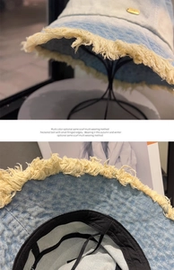 Detail of frayed denim bucket hat featuring blue gradient wash and yellow fringe trim