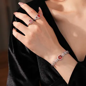 Sparkling zircon flower oval bracelet and ring set with red gemstones on silver finish