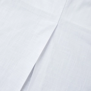 Close-up of white linen fabric texture showing detailed split seam and smooth stitching
