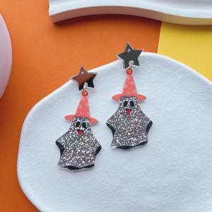 Detail of Halloween ghost earrings with silver glitter and orange wizard hat texture